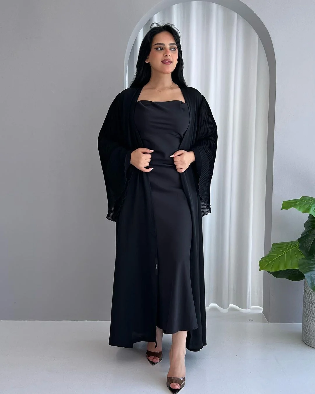 woman standing and wearing black abaya